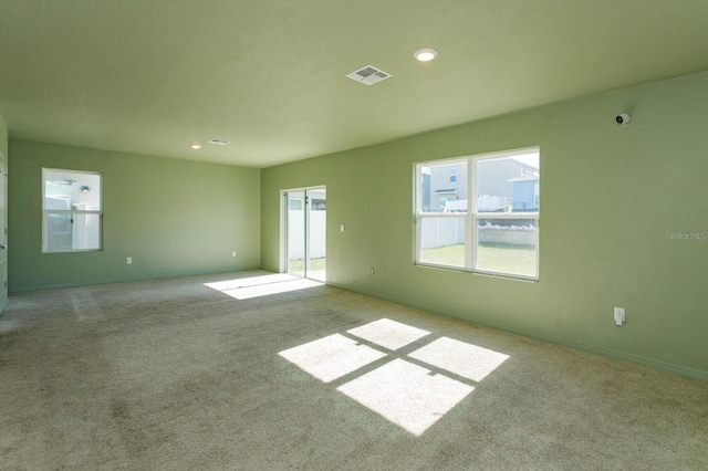 unfurnished room featuring light carpet