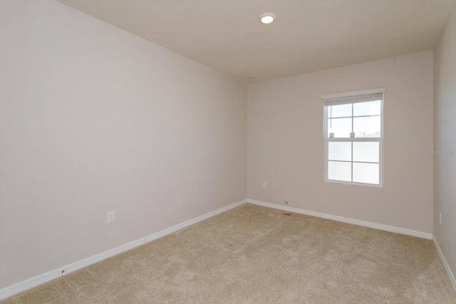 empty room with light colored carpet