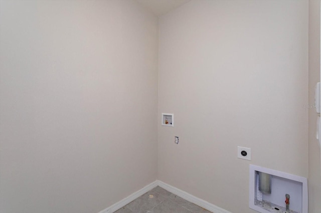 clothes washing area featuring hookup for an electric dryer, hookup for a washing machine, and light tile patterned floors