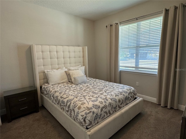 carpeted bedroom featuring a textured ceiling