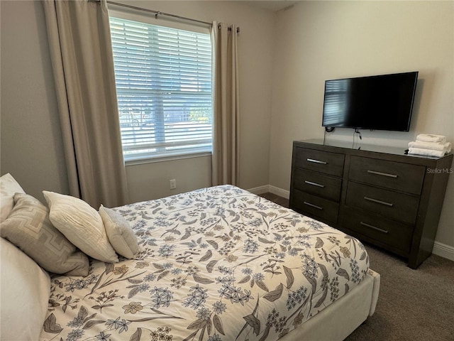 bedroom featuring dark carpet