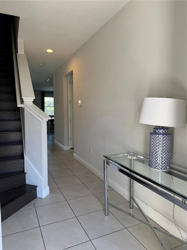 interior space featuring tile patterned flooring and a textured ceiling