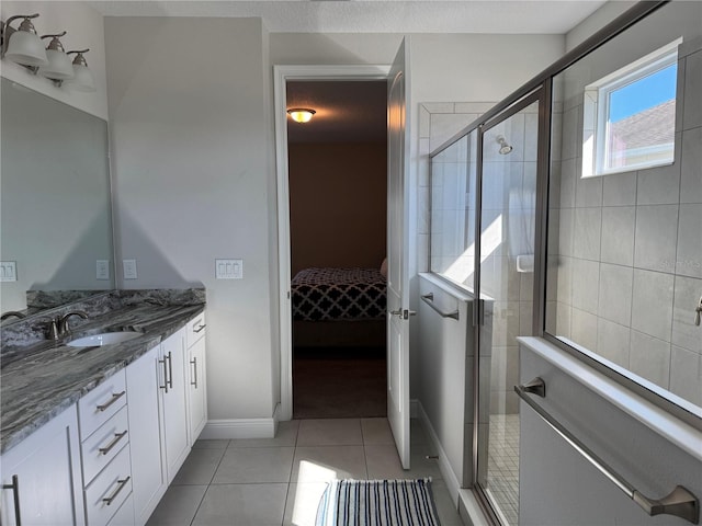 bathroom featuring tile patterned flooring, vanity, and an enclosed shower