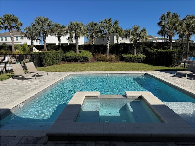 view of swimming pool with a lawn, a patio area, and an in ground hot tub