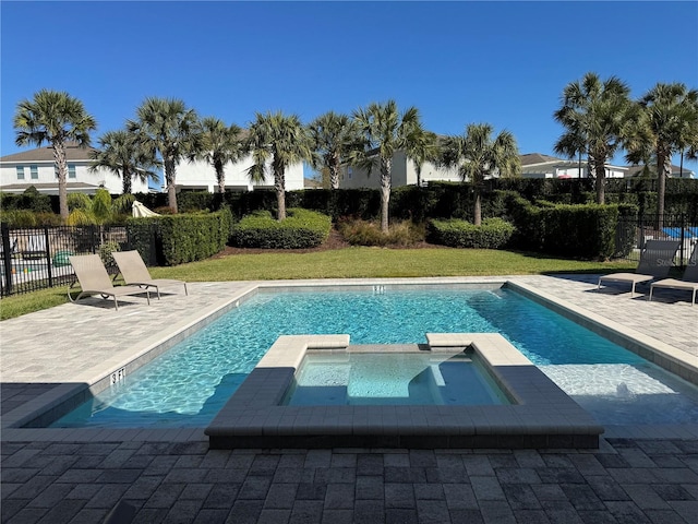 view of pool with a lawn, a patio area, and an in ground hot tub