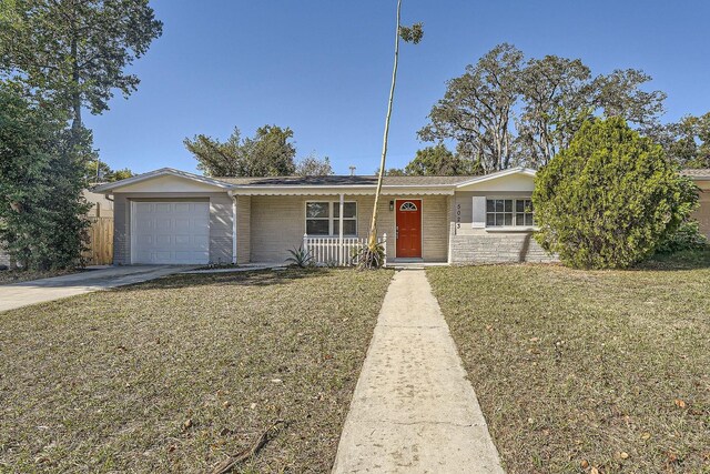 5023 Thames Dr, New Port Richey, FL 34652 - single story home with a garage, driveway, covered porch, and brick siding