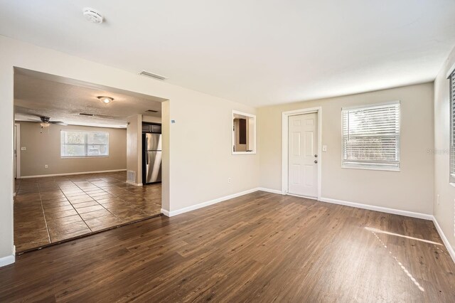 5023 Thames Dr, New Port Richey, FL 34652 - unfurnished room with wood finished floors, baseboards, a ceiling fan, and a smoke detector