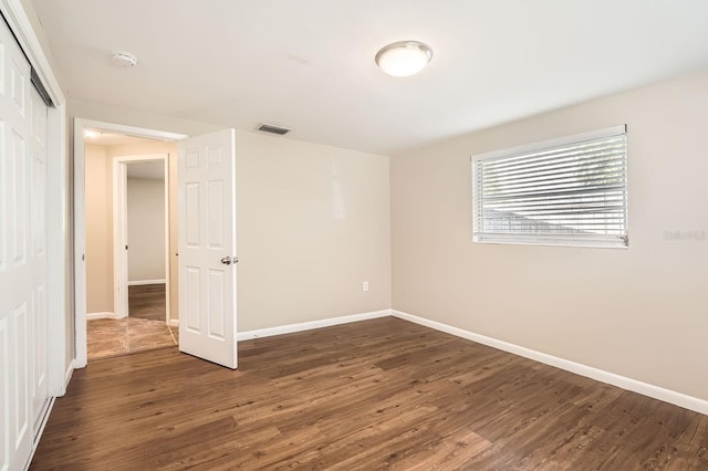 empty room with dark hardwood / wood-style floors