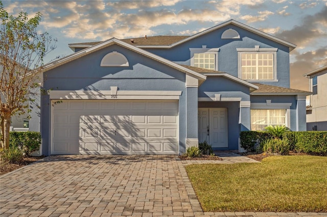 view of front property with a garage and a front lawn