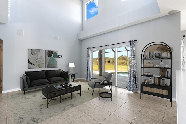 tiled living room featuring a high ceiling