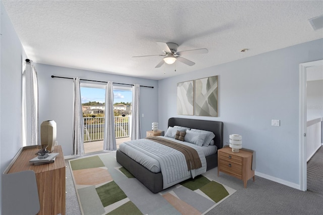 carpeted bedroom featuring a textured ceiling and ceiling fan