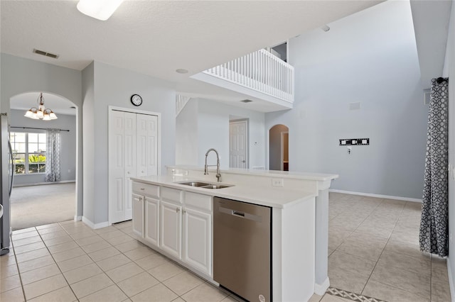 kitchen featuring a kitchen island with sink, sink, white cabinets, and stainless steel appliances