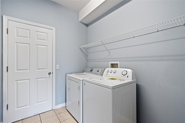 washroom with light tile patterned floors and separate washer and dryer