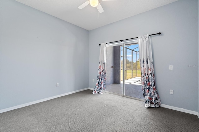 carpeted spare room featuring ceiling fan