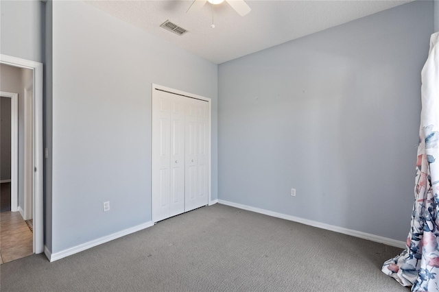 unfurnished bedroom with carpet, ceiling fan, and a closet