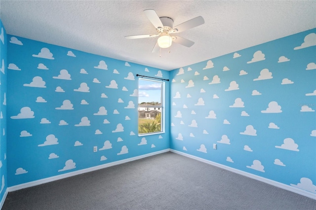 spare room with carpet flooring, ceiling fan, and a textured ceiling