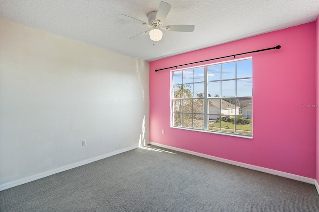 carpeted spare room featuring ceiling fan and a textured ceiling