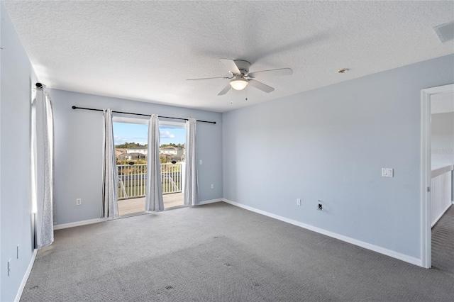 empty room with carpet flooring, a textured ceiling, and ceiling fan