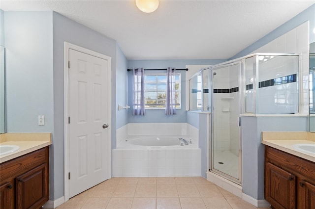 bathroom featuring vanity, tile patterned flooring, and plus walk in shower