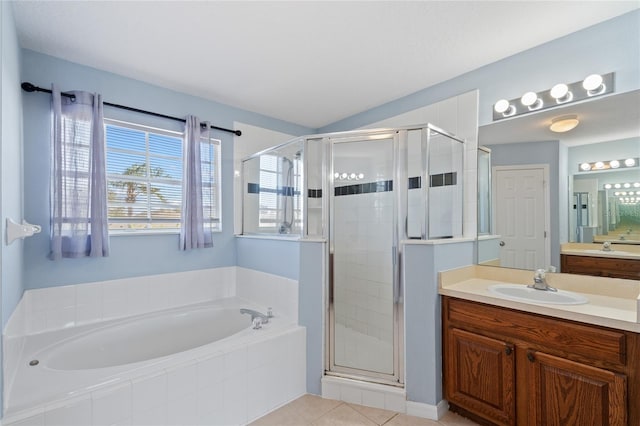 bathroom featuring shower with separate bathtub, vanity, and tile patterned floors