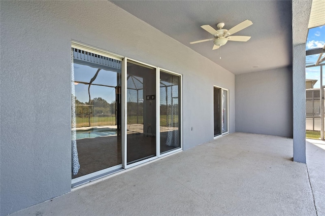 view of patio / terrace with ceiling fan and a lanai