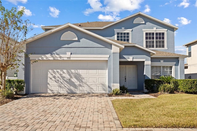 front of property featuring a garage and a front lawn