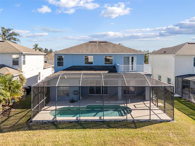 back of property featuring a lawn, a lanai, and a patio