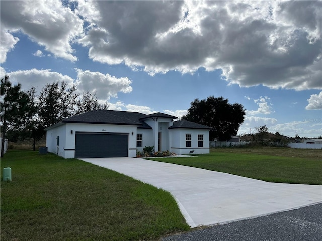 view of front of property featuring a garage, a front yard, and central AC