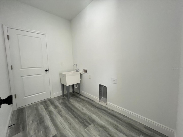 laundry room featuring washer hookup and dark wood-type flooring