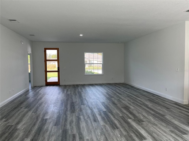 empty room with dark hardwood / wood-style floors