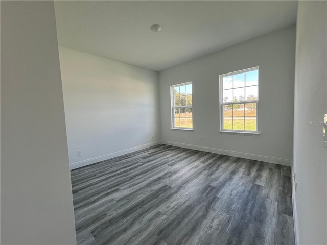 unfurnished room with dark hardwood / wood-style floors