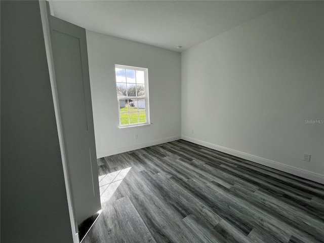 empty room featuring dark wood-type flooring