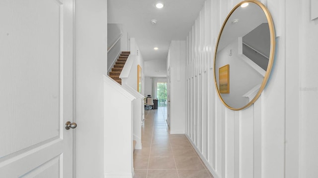 hall featuring light tile patterned flooring