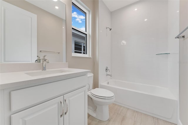 full bathroom featuring tiled shower / bath combo, toilet, and vanity