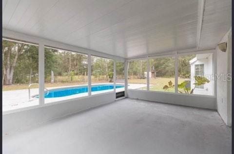 unfurnished sunroom featuring a wealth of natural light