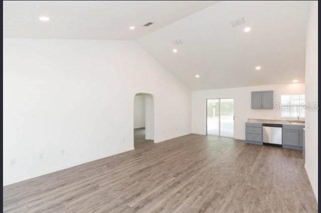 unfurnished living room with lofted ceiling and hardwood / wood-style flooring