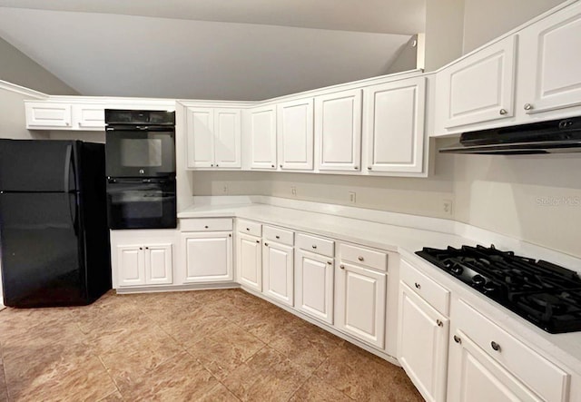 kitchen with white cabinets, black appliances, and vaulted ceiling