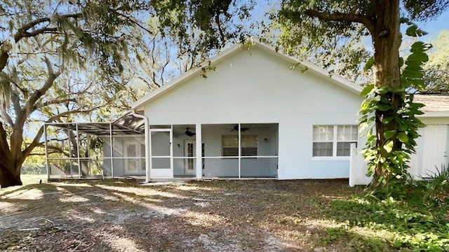 back of property featuring ceiling fan and a lanai