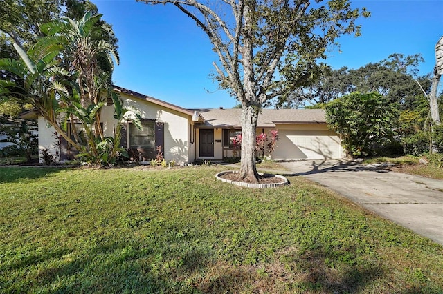 ranch-style home with a garage and a front lawn