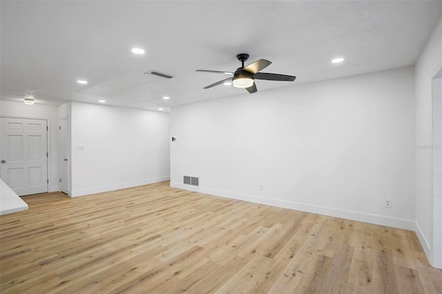 spare room with light wood-type flooring and ceiling fan