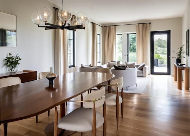 dining area with a chandelier and light wood-type flooring