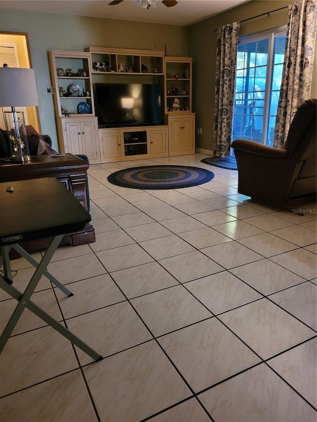 unfurnished living room with ceiling fan and light tile patterned floors