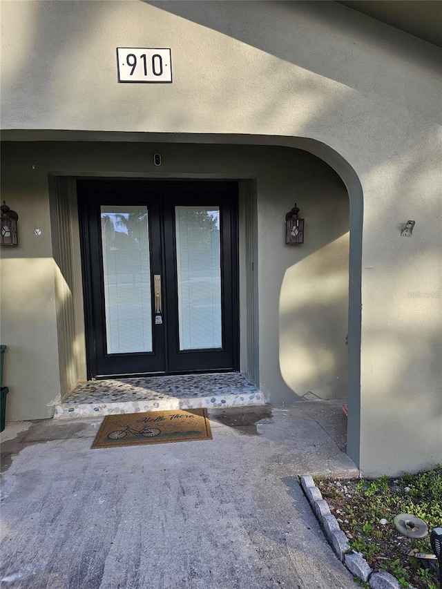 view of exterior entry featuring french doors