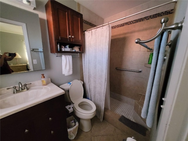 bathroom with a shower with curtain, vanity, toilet, and tile patterned floors