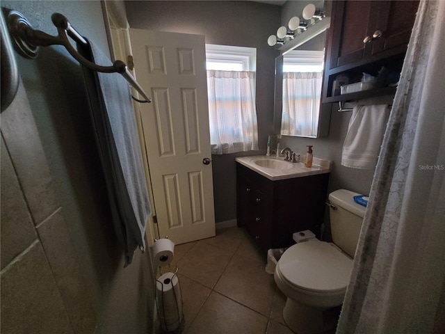 bathroom featuring tile patterned floors, vanity, and toilet