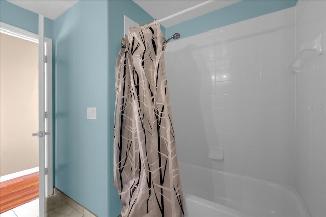 bathroom featuring tile patterned flooring and shower / tub combo with curtain