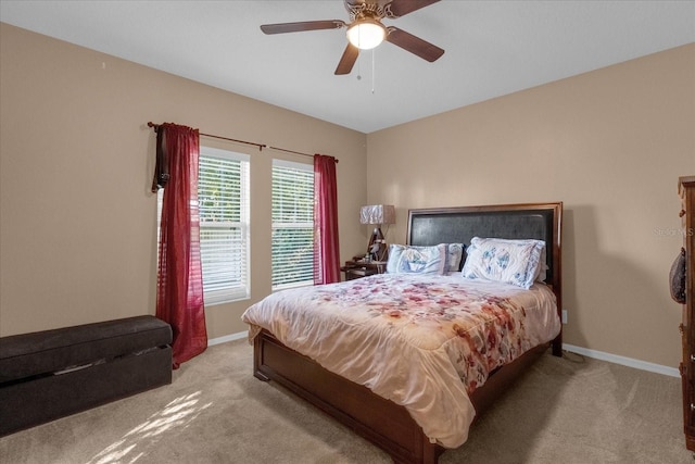 bedroom with ceiling fan and light carpet