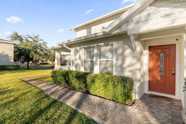 property entrance with a yard