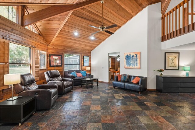 living room with wooden walls, beam ceiling, wood ceiling, and high vaulted ceiling