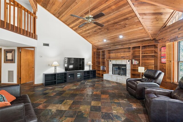 living room featuring built in shelves, high vaulted ceiling, wood ceiling, and a tile fireplace